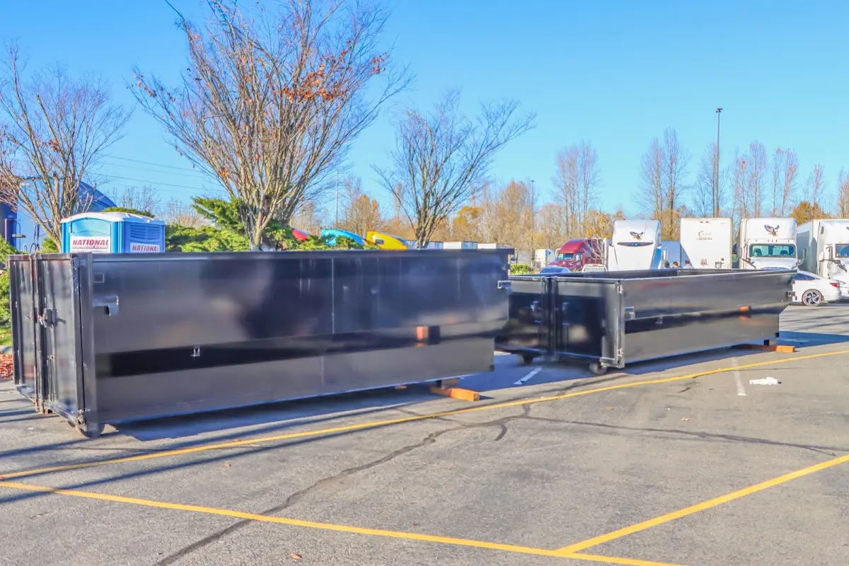 Professional dumpster rental service with roll-off container on residential driveway in Paxton